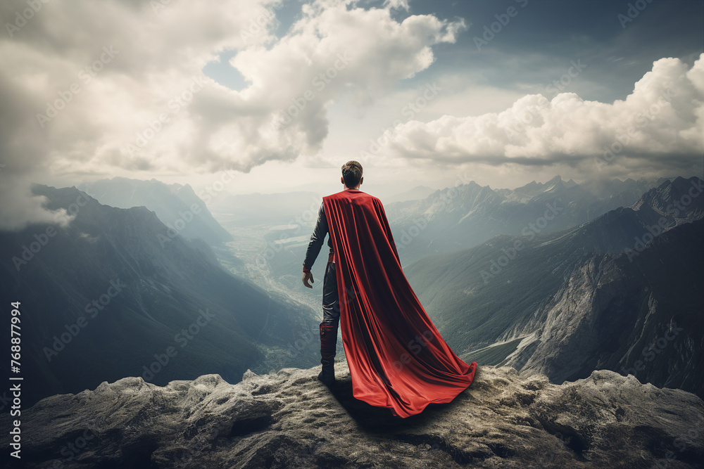 Businessman superhero with red cape standing and looking on the top of mountain landscape generative ai