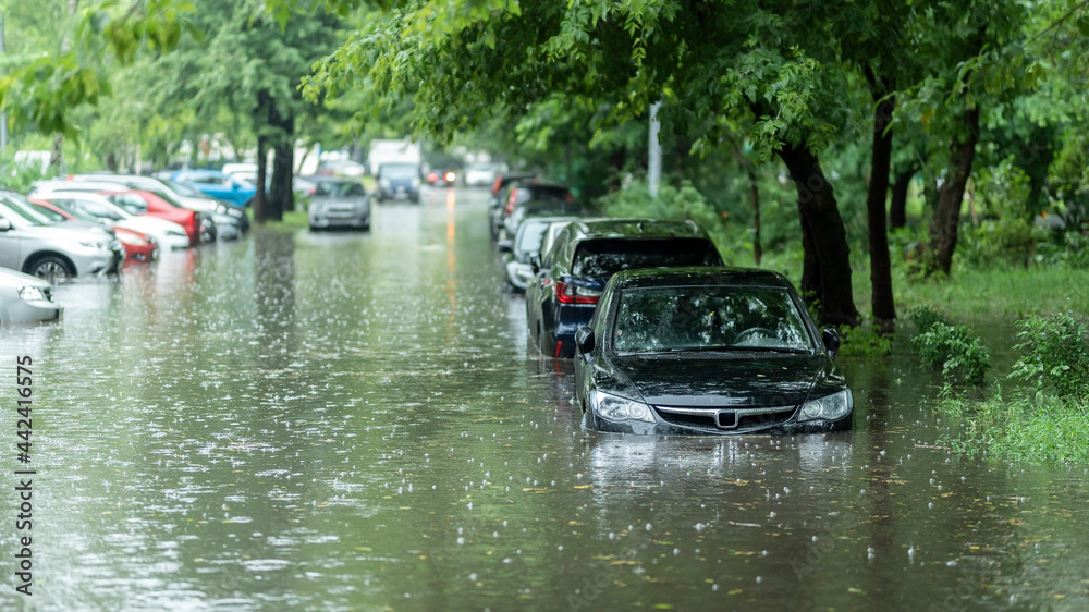 Flooded cars on the street of the city. Street after heavy rain. Water could enter the engine, transmission parts or other places. Disaster Motor Vehicle Insurance Claim Themed. Severe weather concept