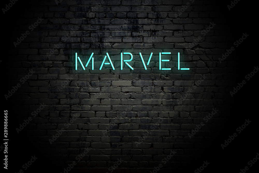 Highlighted brick wall with neon inscription marvel