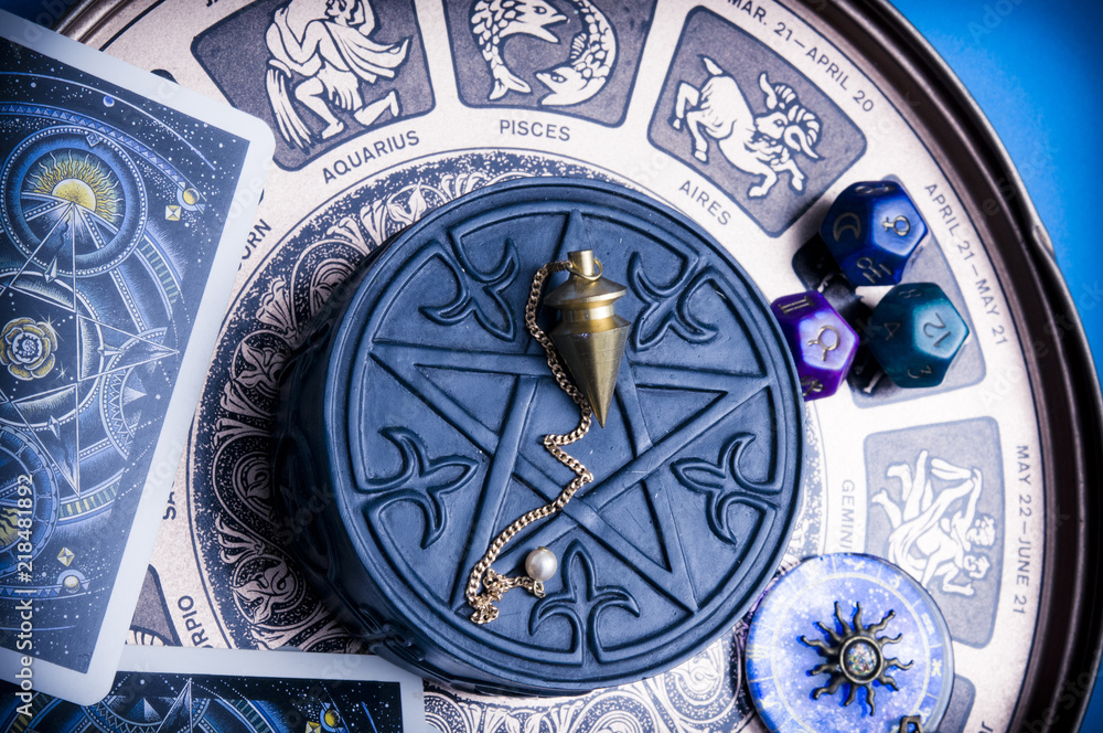 horoscope with zodiac signs, astrology dice, pendulum, pentagram and cars like esoteric concept