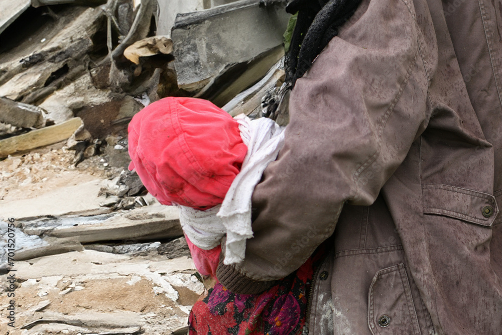 Mother with children near a destroyed house