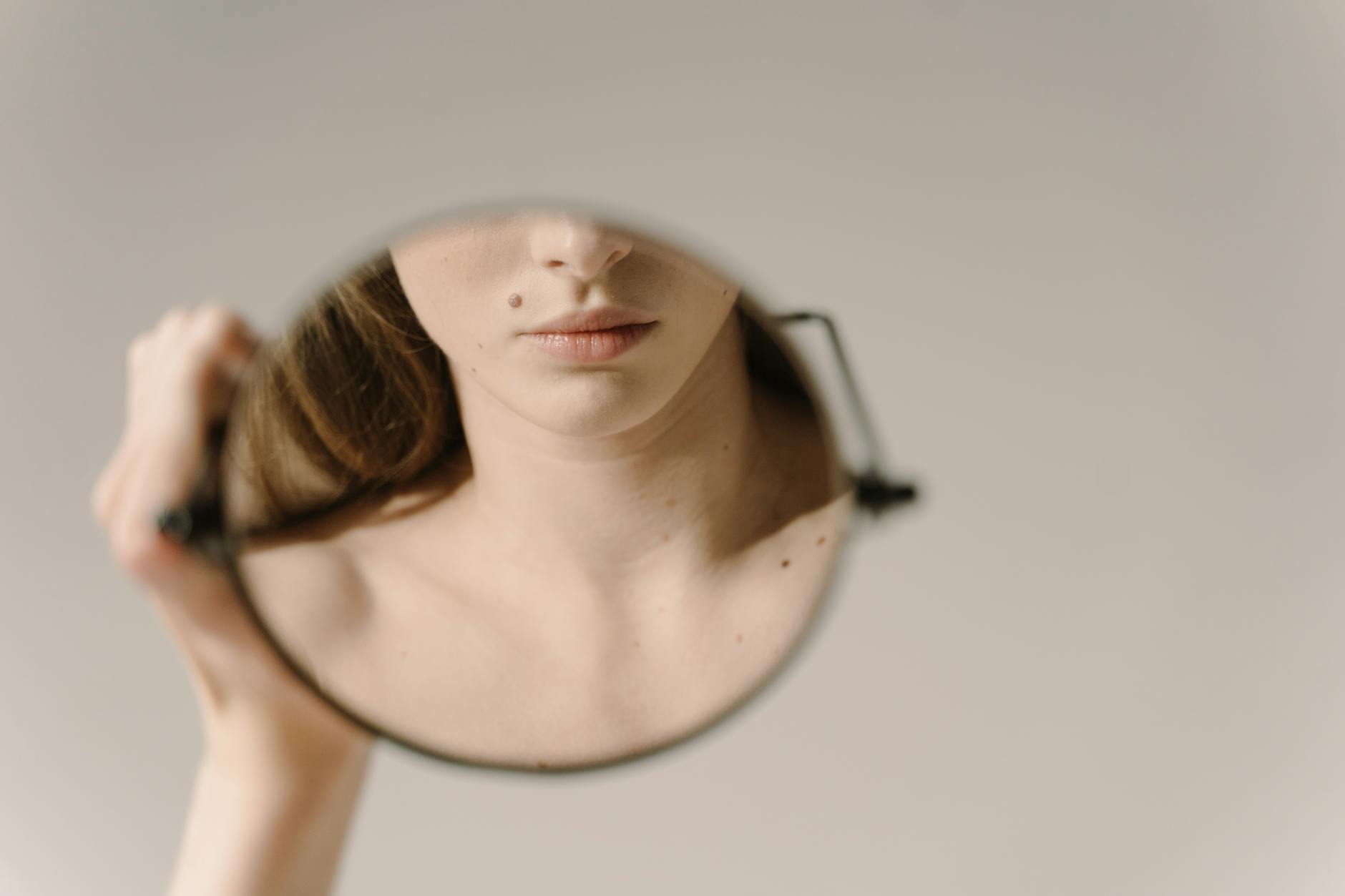 reflection of a mouth with beauty mark