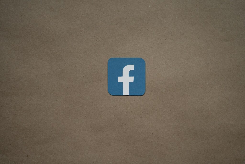 a blue facebook logo on a brown background