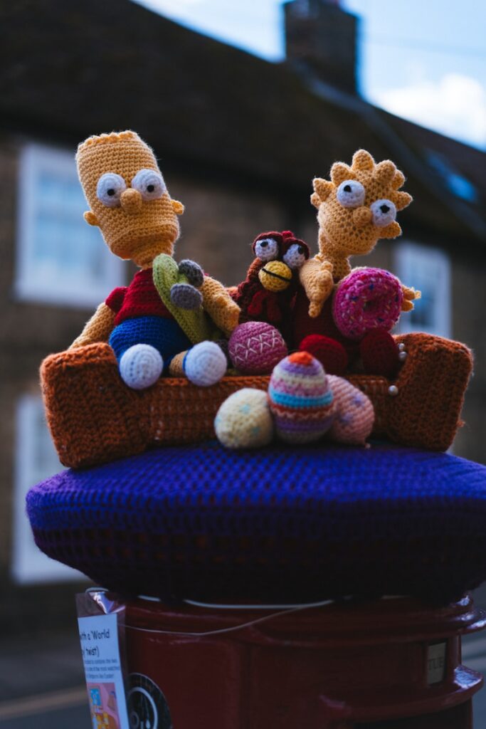 a couple of stuffed animals sitting on top of a fire hydrant