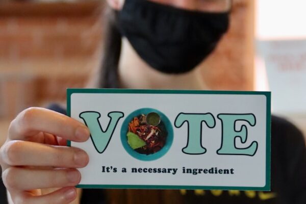 woman holding white and blue box