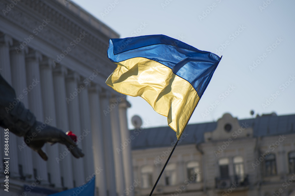 The national flag of Ukraine on Independence Square illuminated by the sun