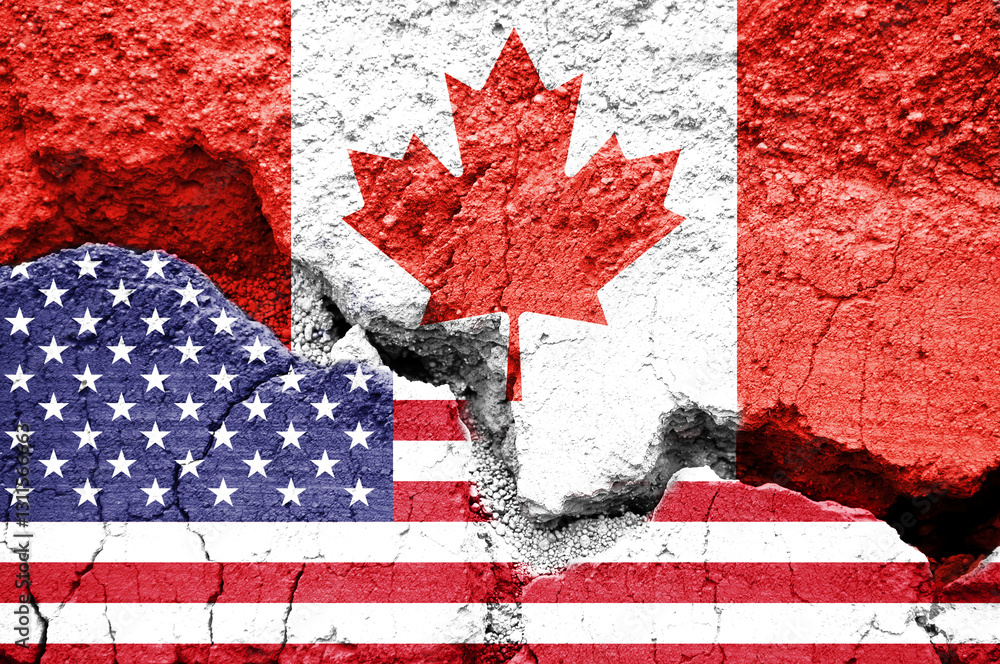 US American and Canadian flags on cracked background. Concept of  diplomatic crisis, tariffs and commercial trade war between United States and Canada